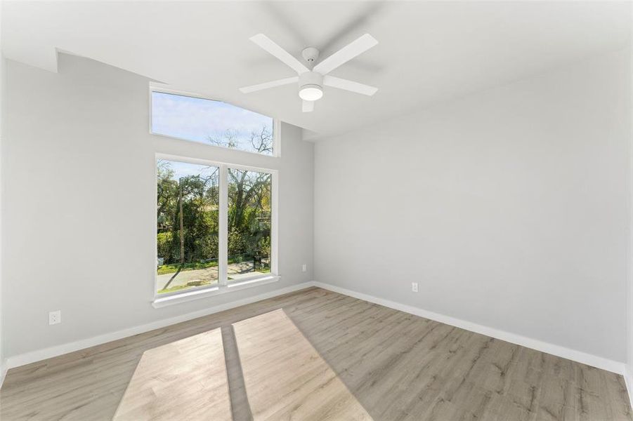 Unfurnished room with light wood-type flooring and ceiling fan