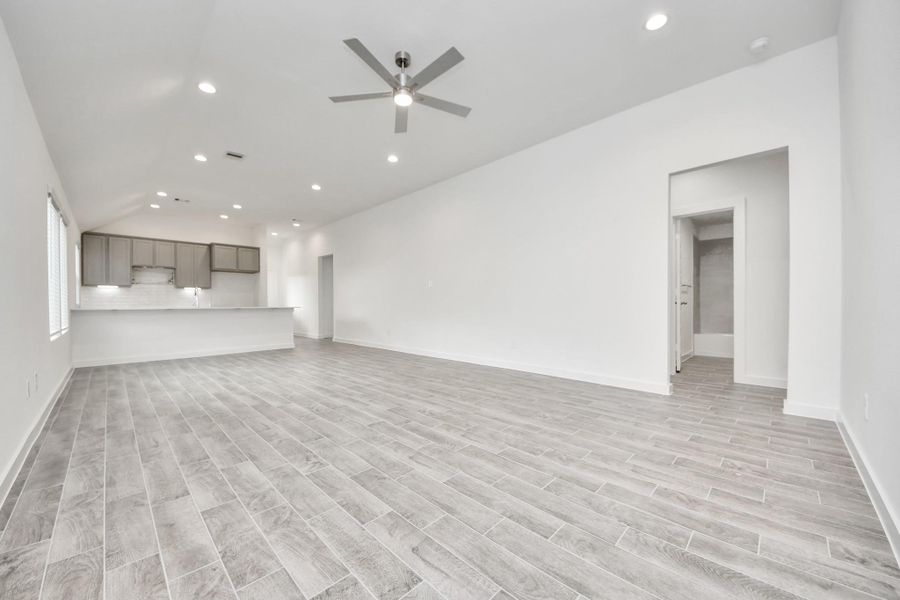 Craft enduring memories with loved ones around the table in this roomy dining area. It boasts stylish flooring, personalized paint, and is conveniently situated next to the family room and kitchen, fostering an open and inclusive ambiance.