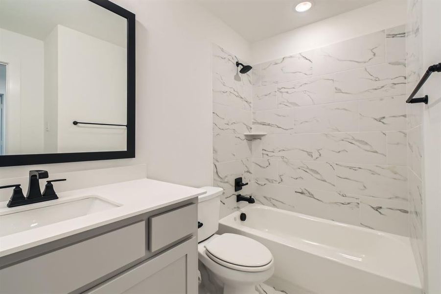Full bathroom featuring vanity, toilet, shower / tub combination, and recessed lighting