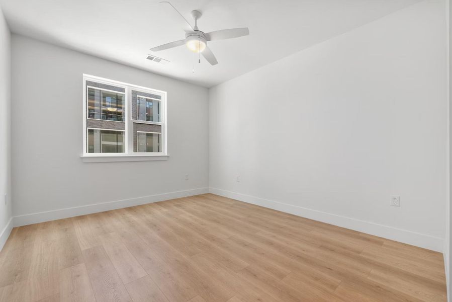Unfurnished room with light wood-style floors and a ceiling fan