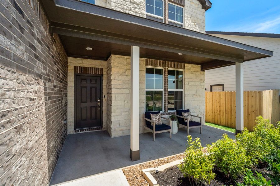 A patio with a table and chairs outside a building. A patio with a table and chairs outside a building.