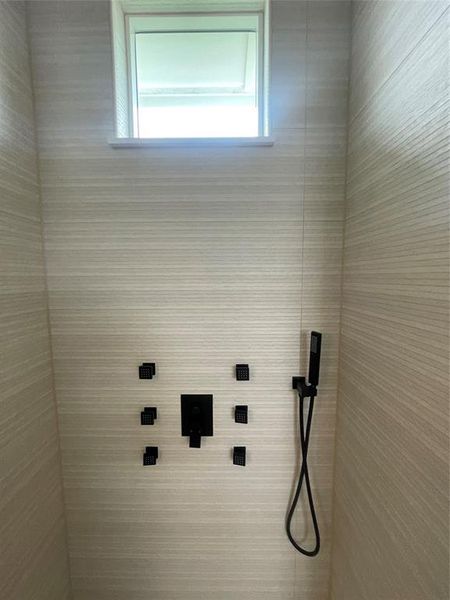 Shower with light-toned horizontal textured tilework