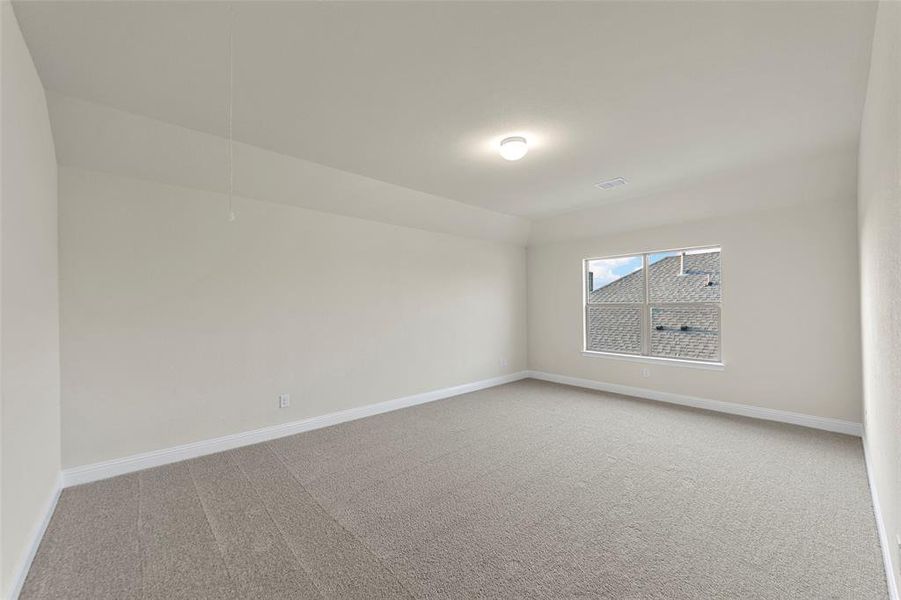 Empty room featuring carpet flooring and baseboards Empty room featuring carpet flooring and baseboards