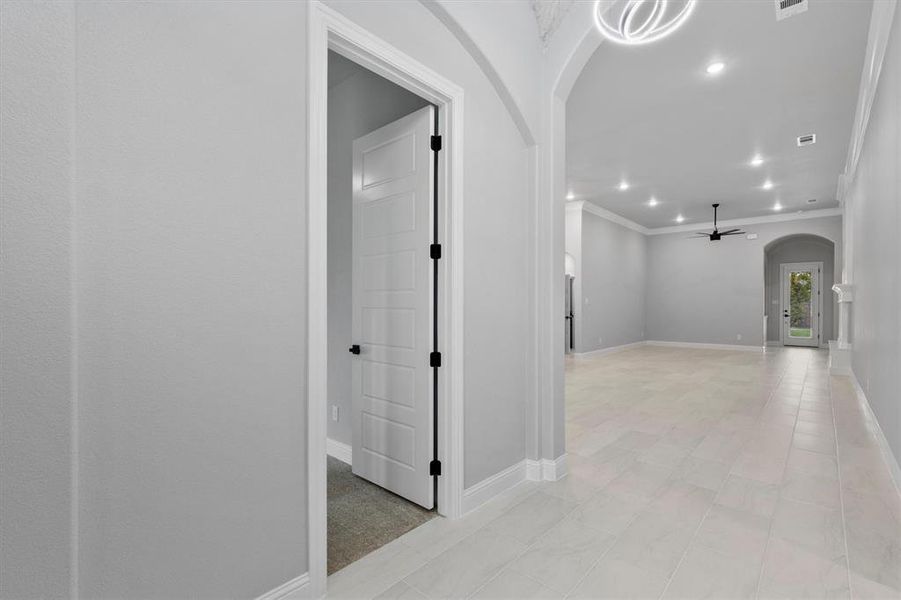 Hallway featuring ornamental molding