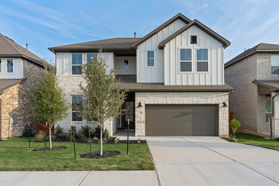Front exterior of a new home in Park Collection at Lariat, Liberty Hill, TX, highlighting curb appeal (Image 1). Front exterior of a new home in Park Collection at Lariat, Liberty Hill, TX, highlighting curb appeal (Image 1).