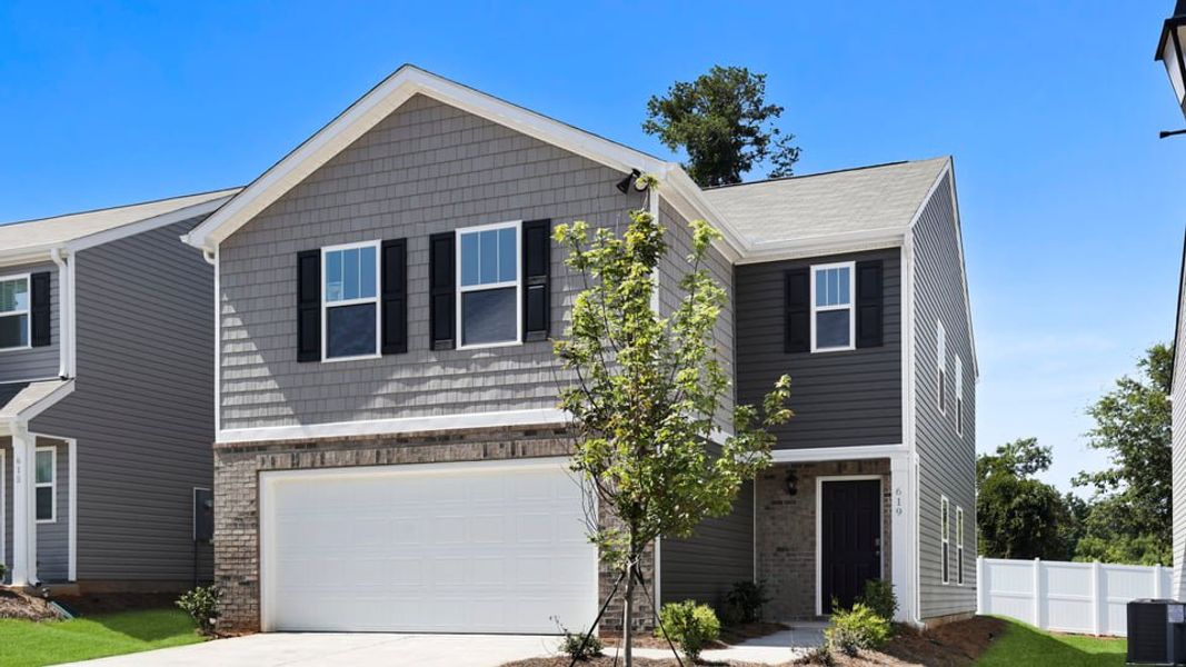 Front exterior of a new home in Cedar Gap, Fountain Inn, SC, highlighting curb appeal (Image 2). Front exterior of a new home in Cedar Gap, Fountain Inn, SC, highlighting curb appeal (Image 2).