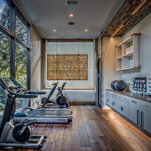 Workout area featuring a wealth of natural light, visible vents, and hardwood / wood-style flooring