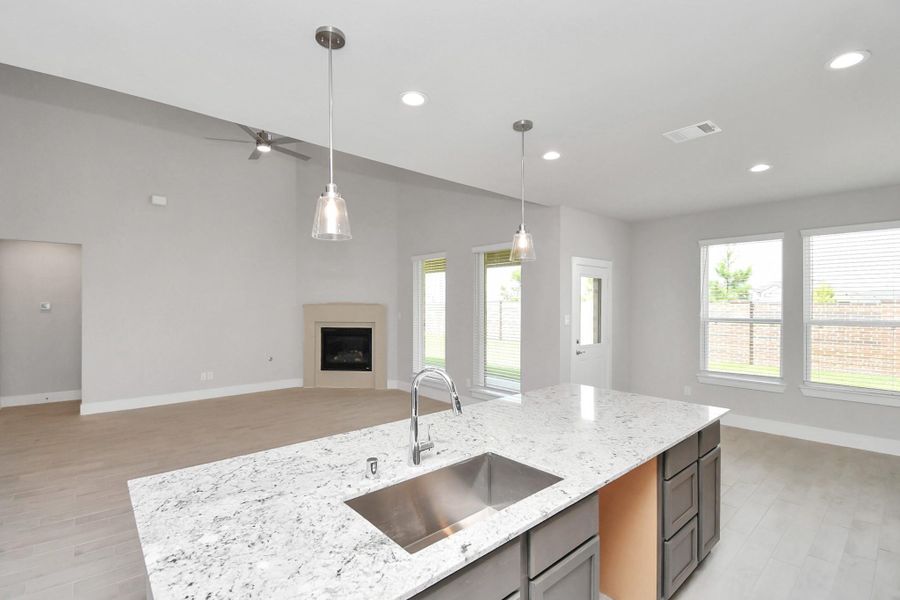 All of this overlooks your expansive family room, creating a perfect space for culinary delights and family gatherings. Sample photo of completed home with similar floor plan. Actual colors and selections may vary.