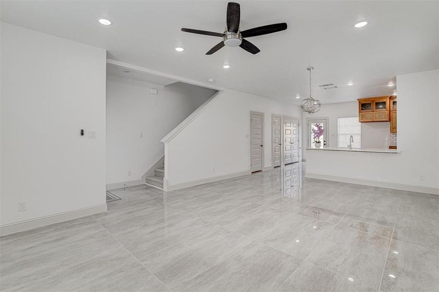living room with recessed lighting, ceiling fan, stairway, and a chandelier