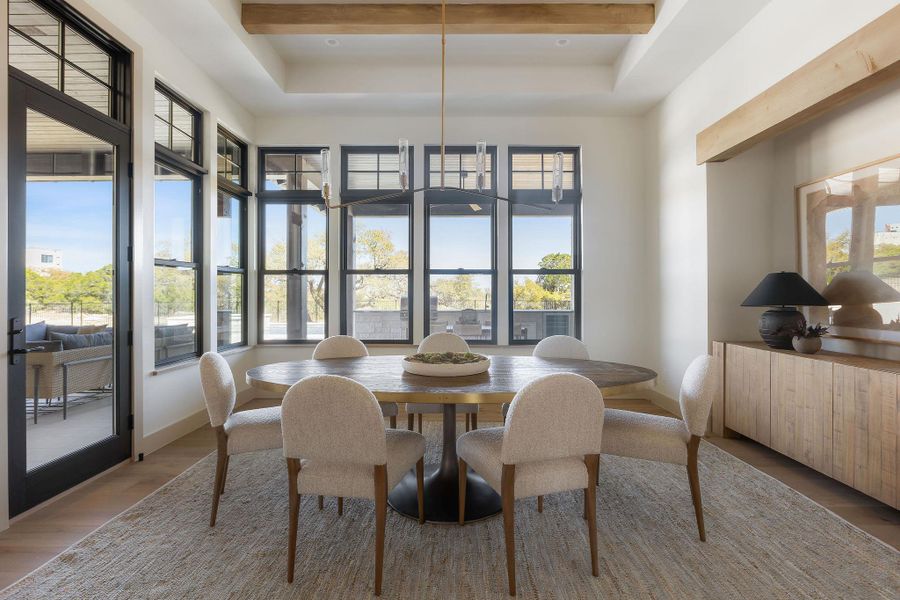 Tons of natural light pour into this dedicated dining area with quick access to the back patio