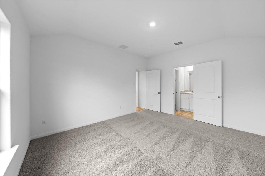 Plush carpeting underfoot complements the clean walls and high ceiling in this quiet retreat.