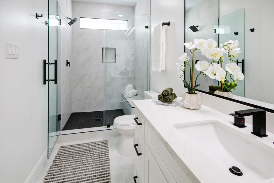 First floor en suite bathroom. Tons of storage and space not to mention the gorgeous shower.