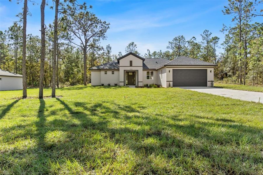 Front exterior of a new home in , Weeki Wachee, FL, highlighting curb appeal (Image 38). Front exterior of a new home in , Weeki Wachee, FL, highlighting curb appeal (Image 38).