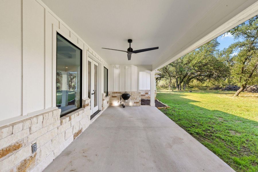 View of patio / terrace with french doors and a ceiling fan