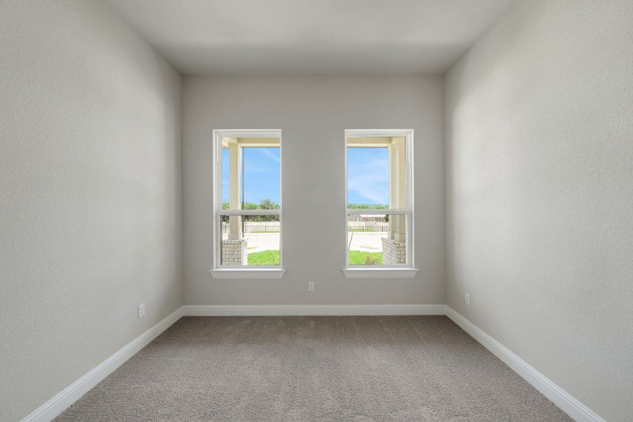 Spare room featuring carpet floors and baseboards Spare room featuring carpet floors and baseboards
