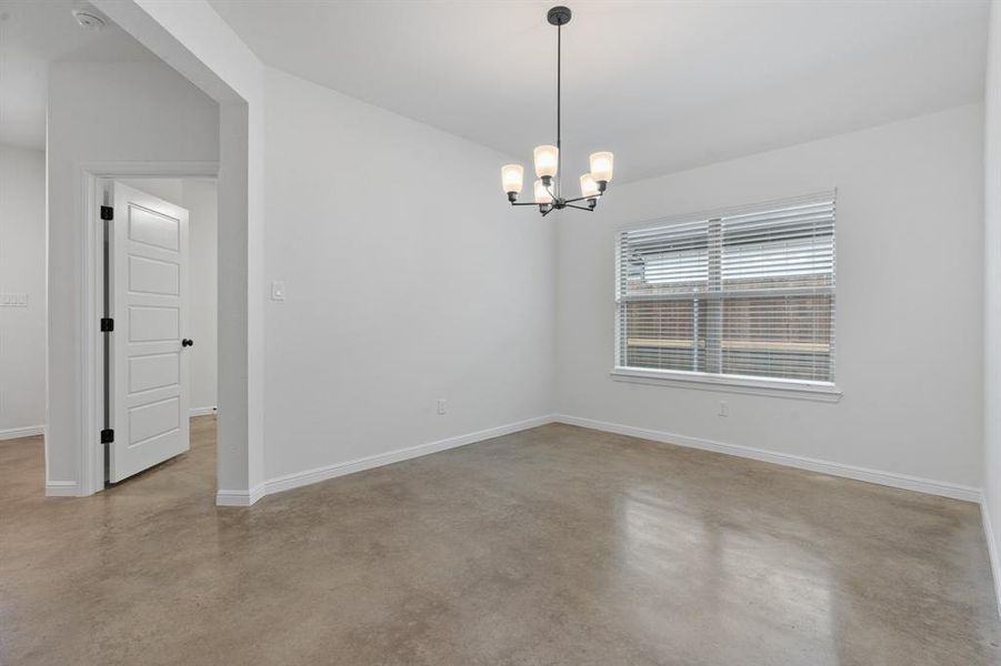 Unfurnished room with a chandelier