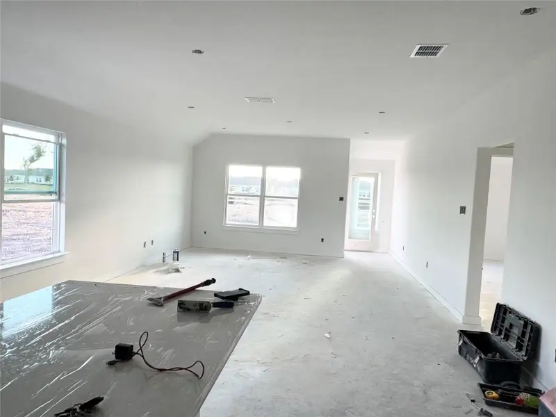 Unfurnished living room with baseboards