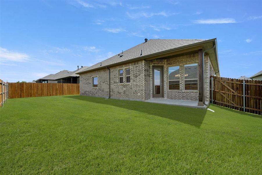 Back of house featuring brick siding, a fenced backyard, a patio, and a shingled roof Back of house featuring brick siding, a fenced backyard, a patio, and a shingled roof