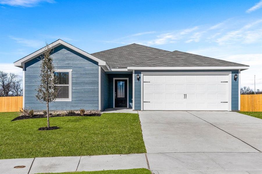 Ranch-style house featuring a garage and a front lawn