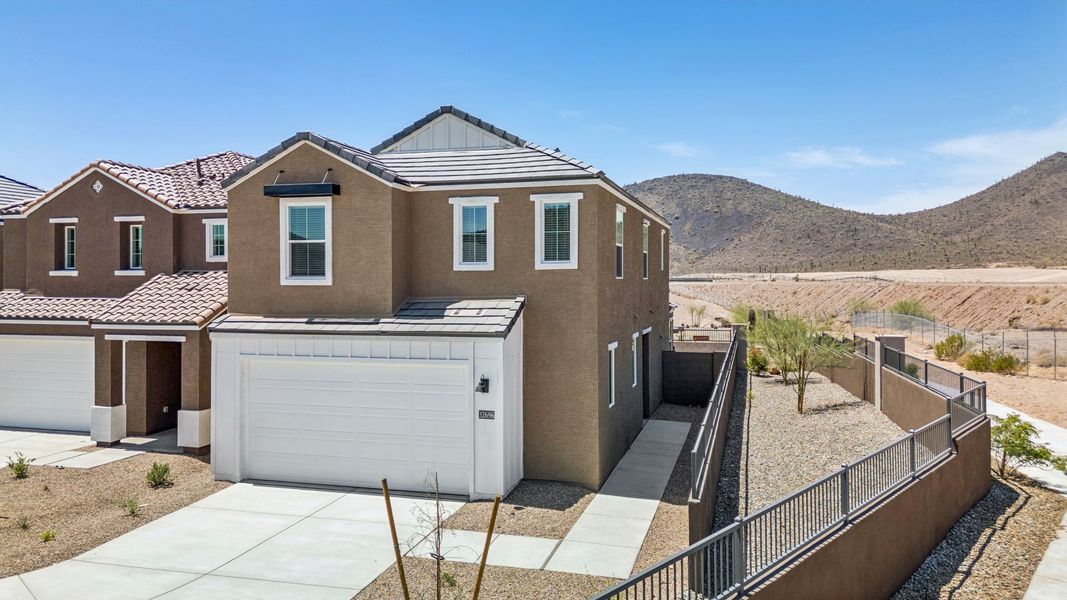 Front exterior of a new home in The Buttes at Mystic, Peoria, AZ, highlighting curb appeal (Image 21). Front exterior of a new home in The Buttes at Mystic, Peoria, AZ, highlighting curb appeal (Image 21).