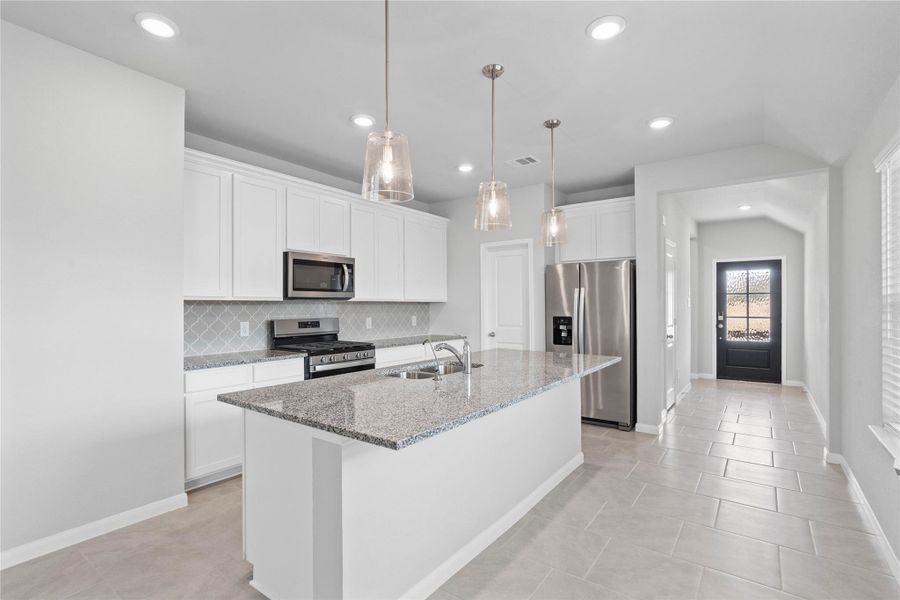 The expansive granite-topped island stands as the home's true heartbeat, offering a natural gathering spot where family and friends naturally gravitate to share meals, conversation, and connection.