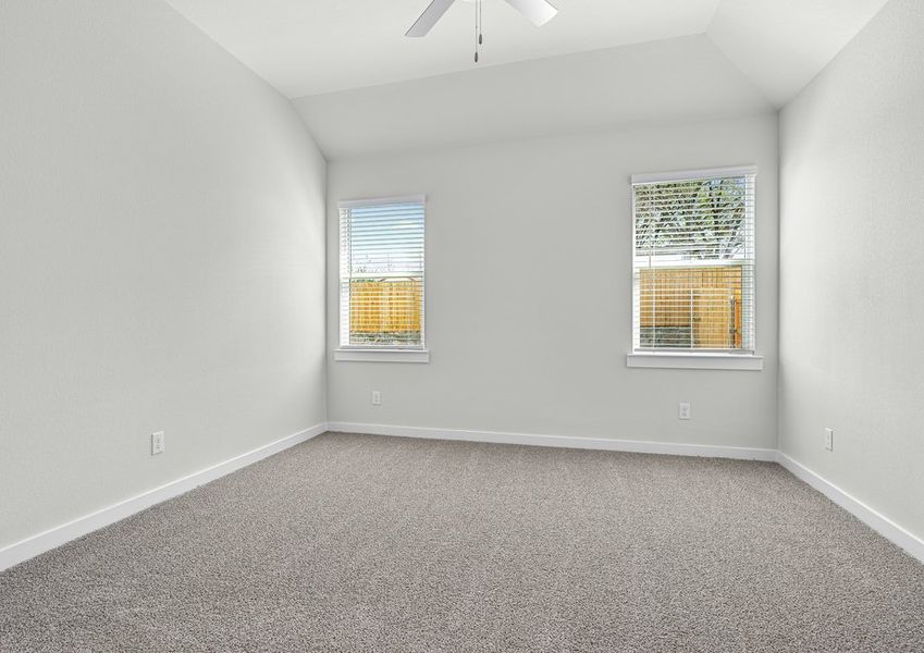 The spacious master bedroom has two windows that lets in great, natural light and backyard views.