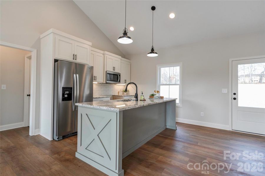 Kitchen has a center island. Kitchen has a center island.