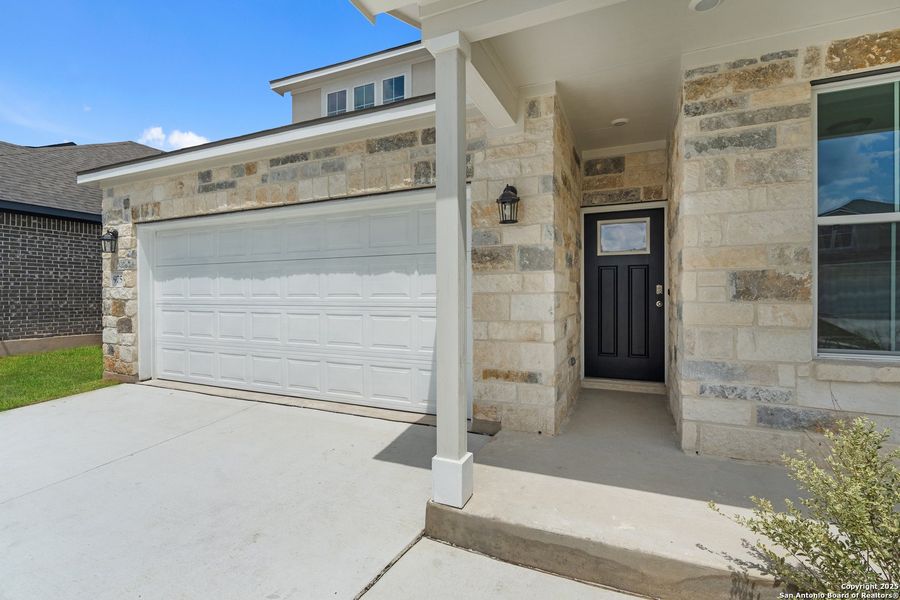 Front exterior of a new home in August Fields, New Braunfels, TX, highlighting curb appeal (Image 22).
