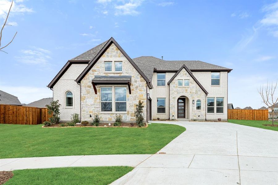 Front exterior of a new home in ArrowBrooke, Aubrey, TX, highlighting curb appeal (Image 1). Front exterior of a new home in ArrowBrooke, Aubrey, TX, highlighting curb appeal (Image 1).