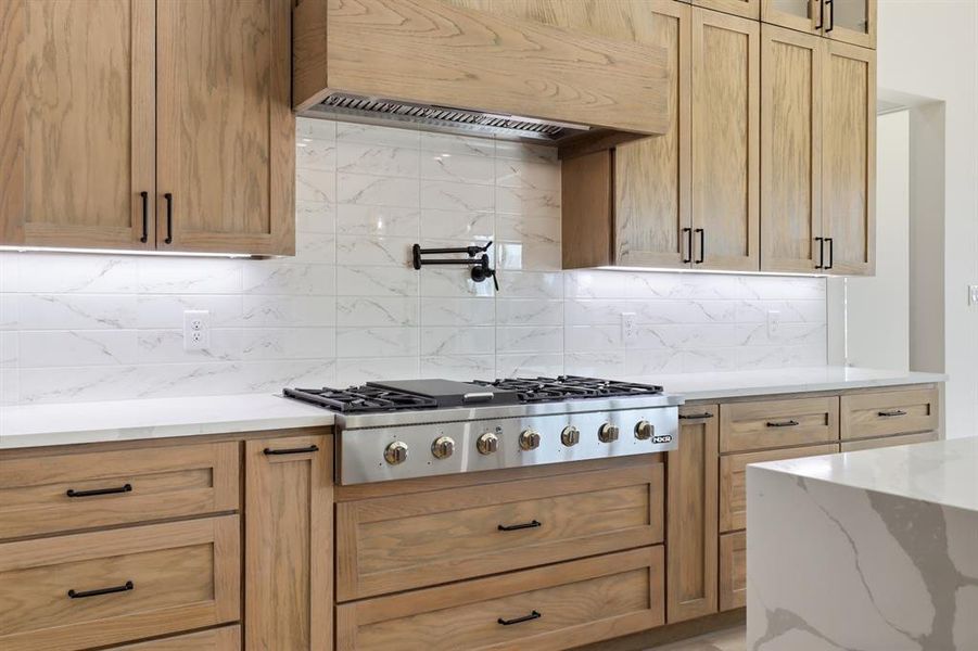 Gas cooktop with pot filler. Gas cooktop with pot filler.