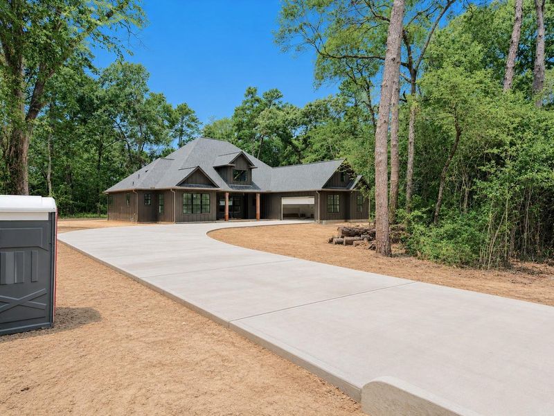 Front exterior of a new home in , Plantersville, TX, highlighting curb appeal (Image 27).