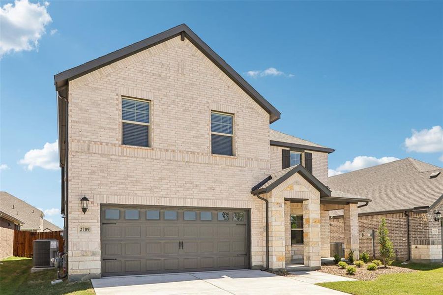 Front exterior of a new home in Parks at Foster Crossing - Premier Series, Anna, TX, highlighting curb appeal (Image 2). Front exterior of a new home in Parks at Foster Crossing - Premier Series, Anna, TX, highlighting curb appeal (Image 2).