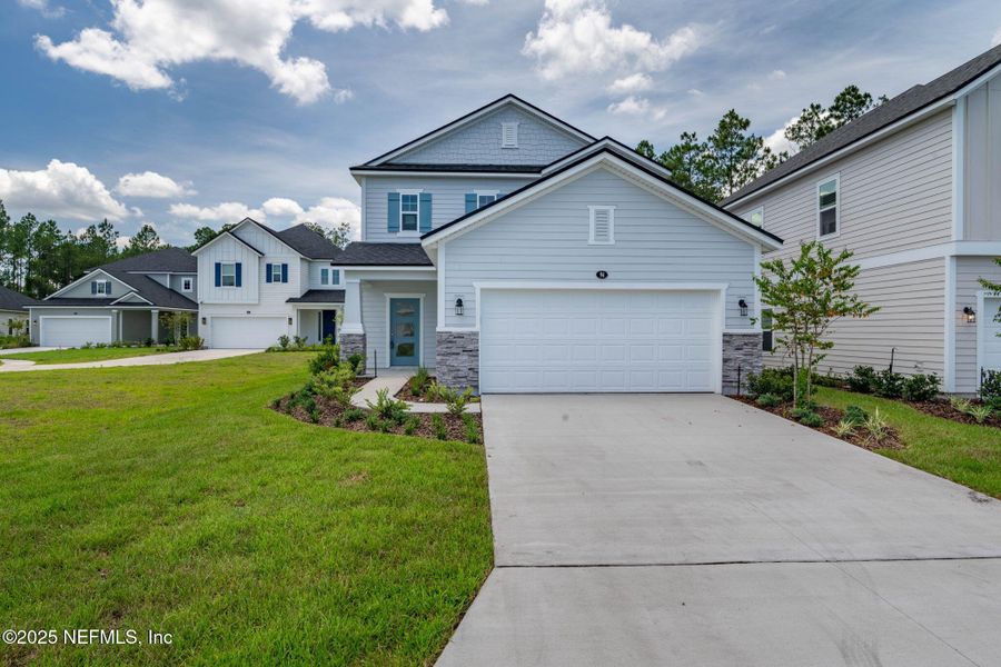 Front exterior of a new home in Beacon Lake, St. Augustine, FL, highlighting curb appeal (Image 38).