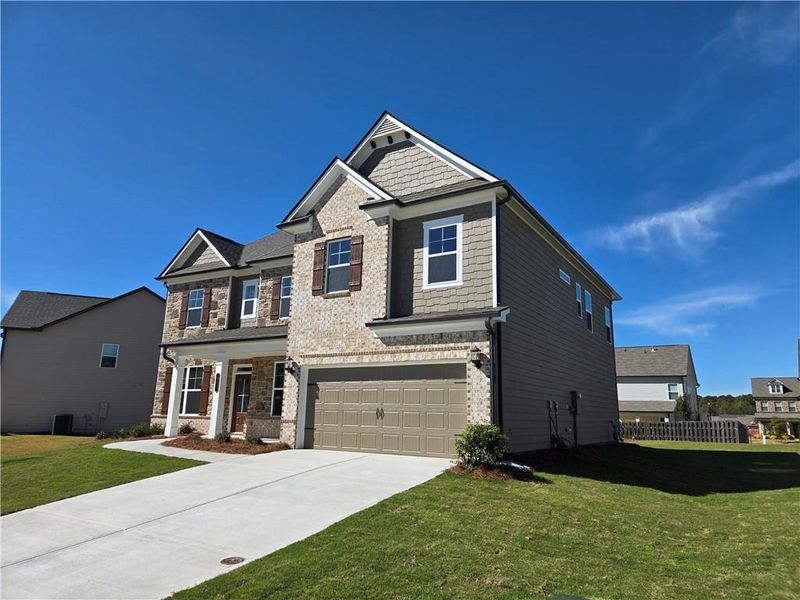 Front exterior of a new home in Enclave at Logan Point, Loganville, GA, highlighting curb appeal (Image 2).
