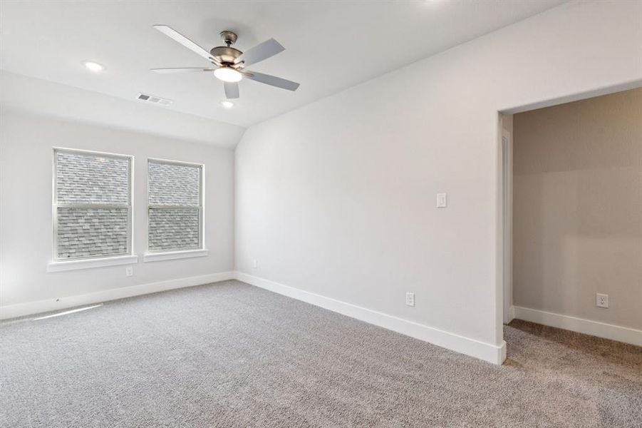 Spare room with light carpet, a ceiling fan, vaulted ceiling, and recessed lighting Spare room with light carpet, a ceiling fan, vaulted ceiling, and recessed lighting