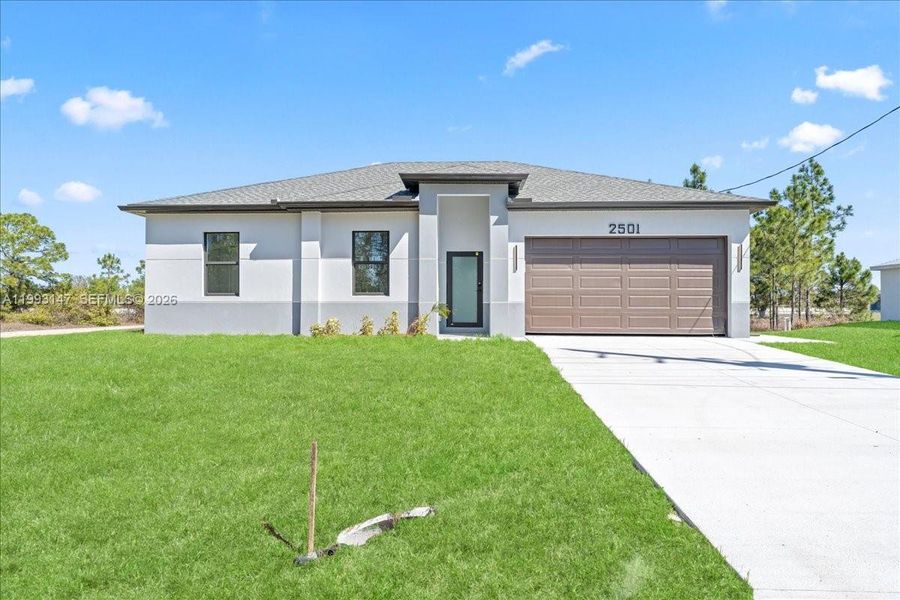 Front exterior of a new home in , Lehigh Acres, FL, highlighting curb appeal (Image 6).