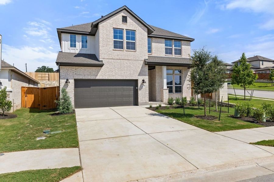Front exterior of a new home in Lariat, Liberty Hill, TX, highlighting curb appeal (Image 2). Front exterior of a new home in Lariat, Liberty Hill, TX, highlighting curb appeal (Image 2).