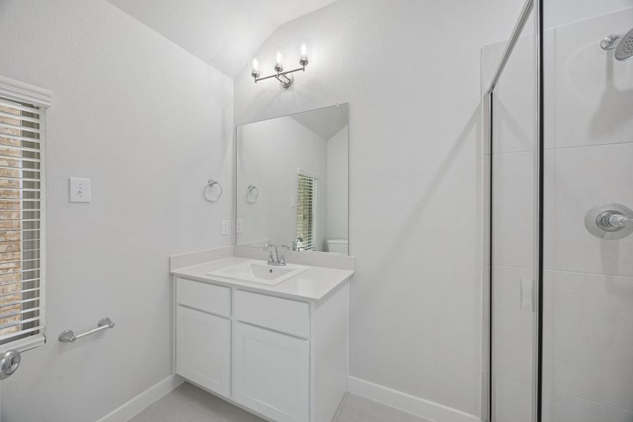 Bathroom in the Masters home plan by Trophy Signature Homes – REPRESENTATIVE PHOTO