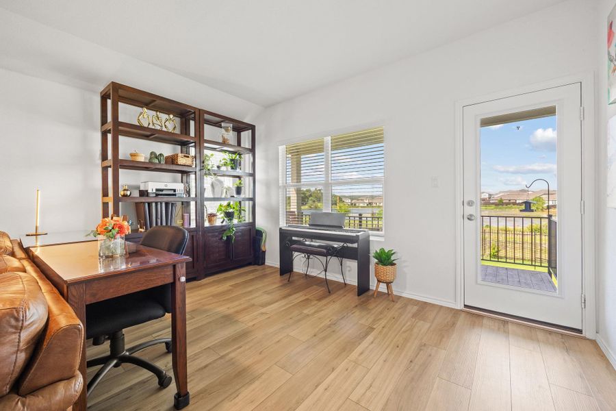 One end of the living room is currently being used as Home Office space which opens onto a charming balcony with views of the lake behind. One end of the living room is currently being used as Home Office space which opens onto a charming balcony with views of the lake behind.