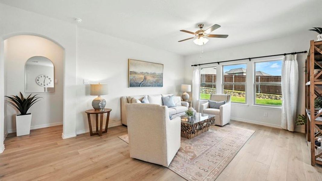The living area features light-toned flooring and white walls, offering a bright and expansive feel