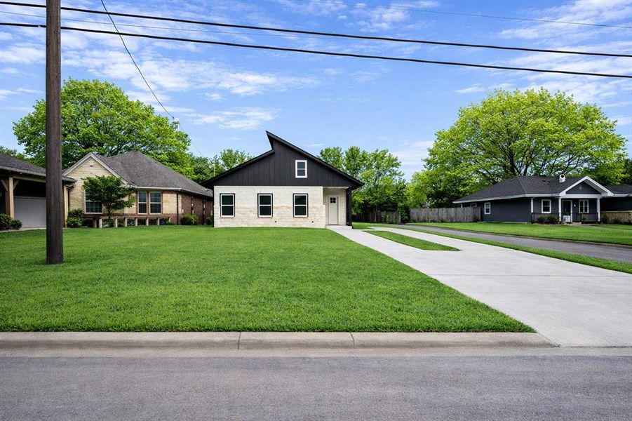 Front exterior of a new home in , Greenville, TX, highlighting curb appeal (Image 2). Front exterior of a new home in , Greenville, TX, highlighting curb appeal (Image 2).