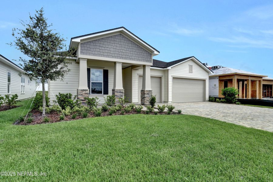 Front exterior of a new home in Reverie at Silverleaf, St. Augustine, FL, highlighting curb appeal (Image 15).
