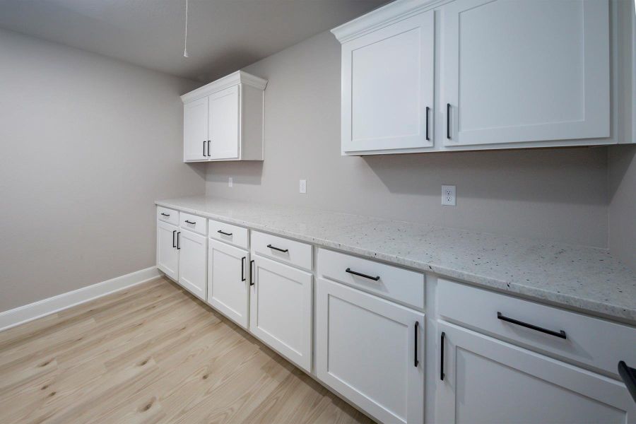 The upstairs utility room has plenty of cabinets for storage and lots of counter space for folding clothes. The upstairs utility room has plenty of cabinets for storage and lots of counter space for folding clothes.