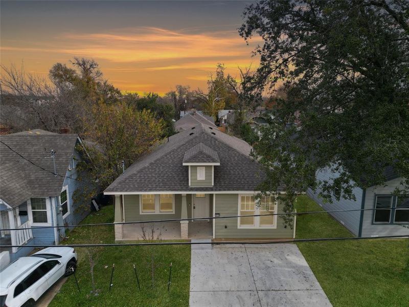 View of front of home featuring a front yard, a shingled roof, and a porch View of front of home featuring a front yard, a shingled roof, and a porch
