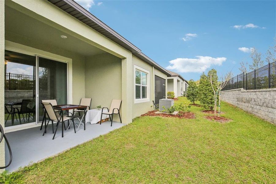 View of the patio and rear of home. View of the patio and rear of home.