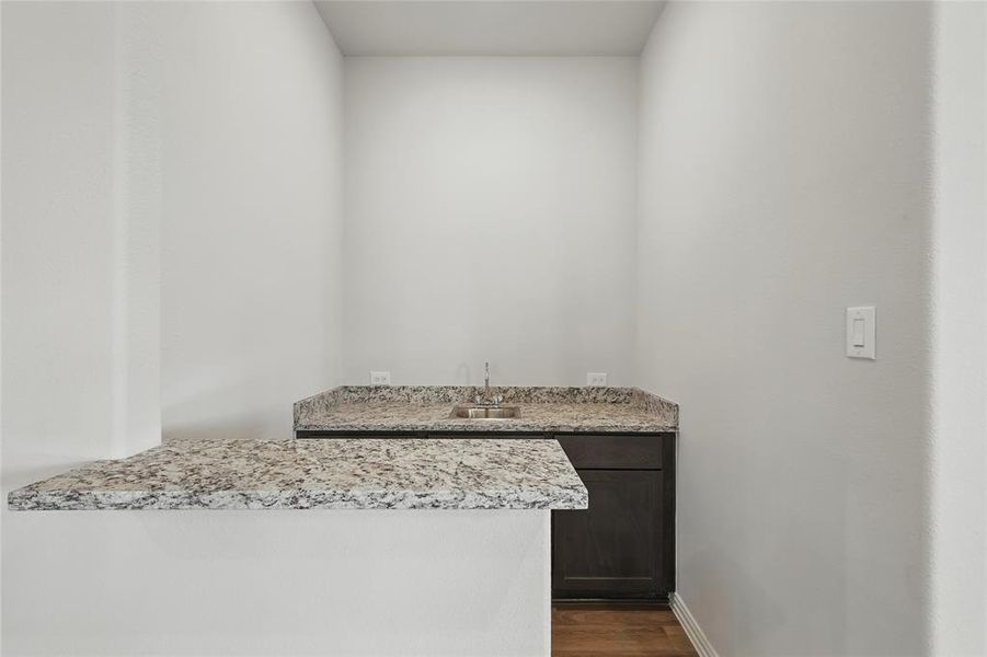 Bathroom featuring vanity, wood finished floors, and baseboards Bathroom featuring vanity, wood finished floors, and baseboards