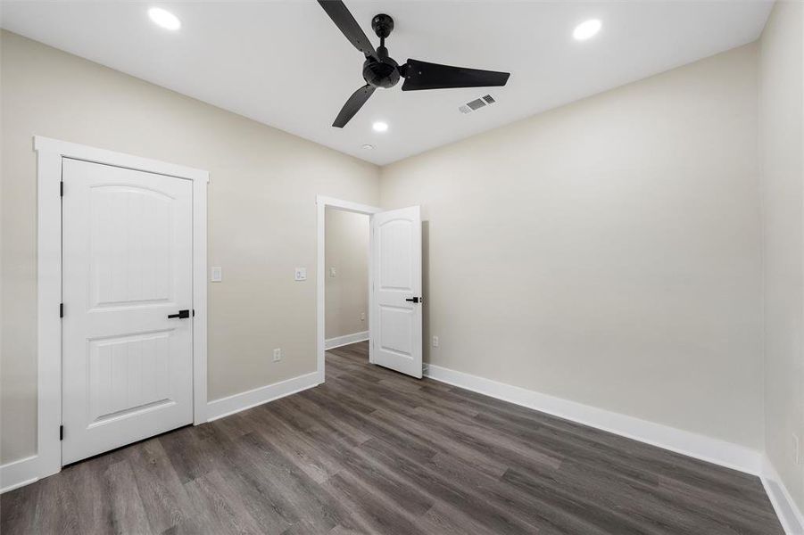Unfurnished bedroom featuring dark wood-style floors, baseboards, recessed lighting, and ceiling fan
