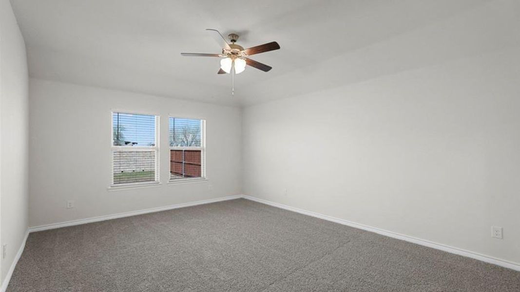 Spacious room featuring neutral carpeting and white walls