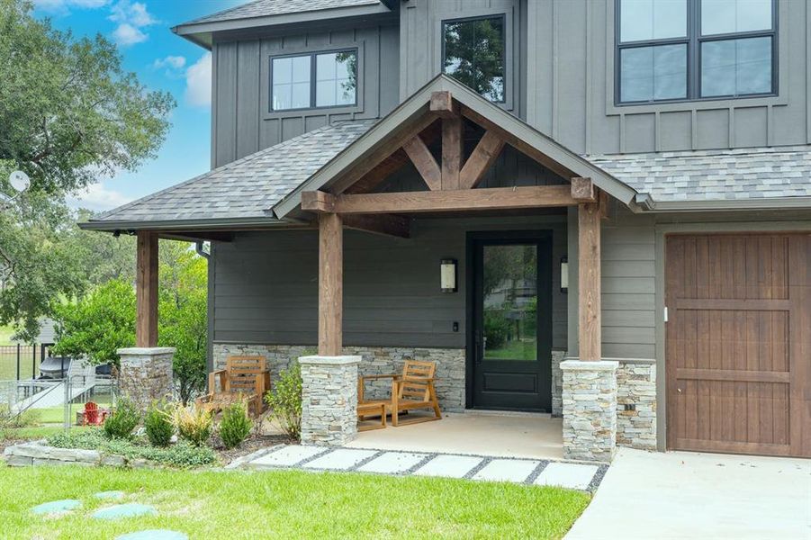 Entrance to property featuring a garage and covered porch