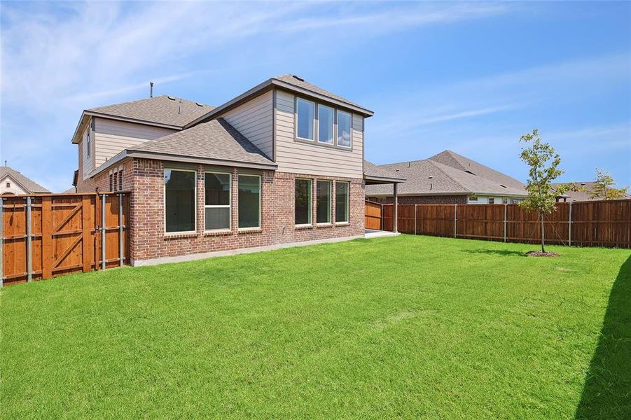 Rear view of house with a lawn